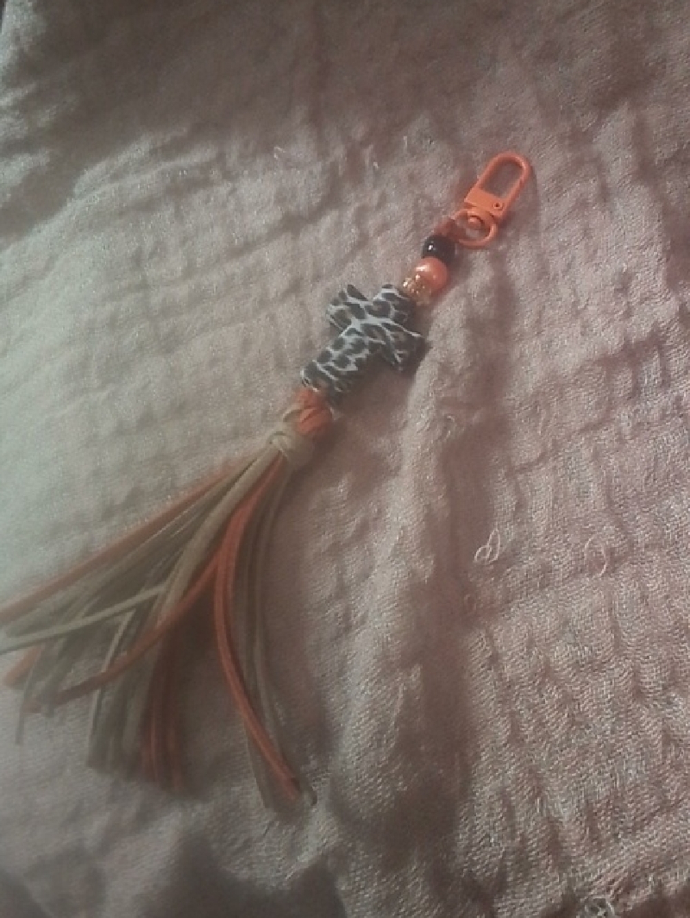 Leather Tassel Keychain with Orange Accent and Giraffe Print Charm